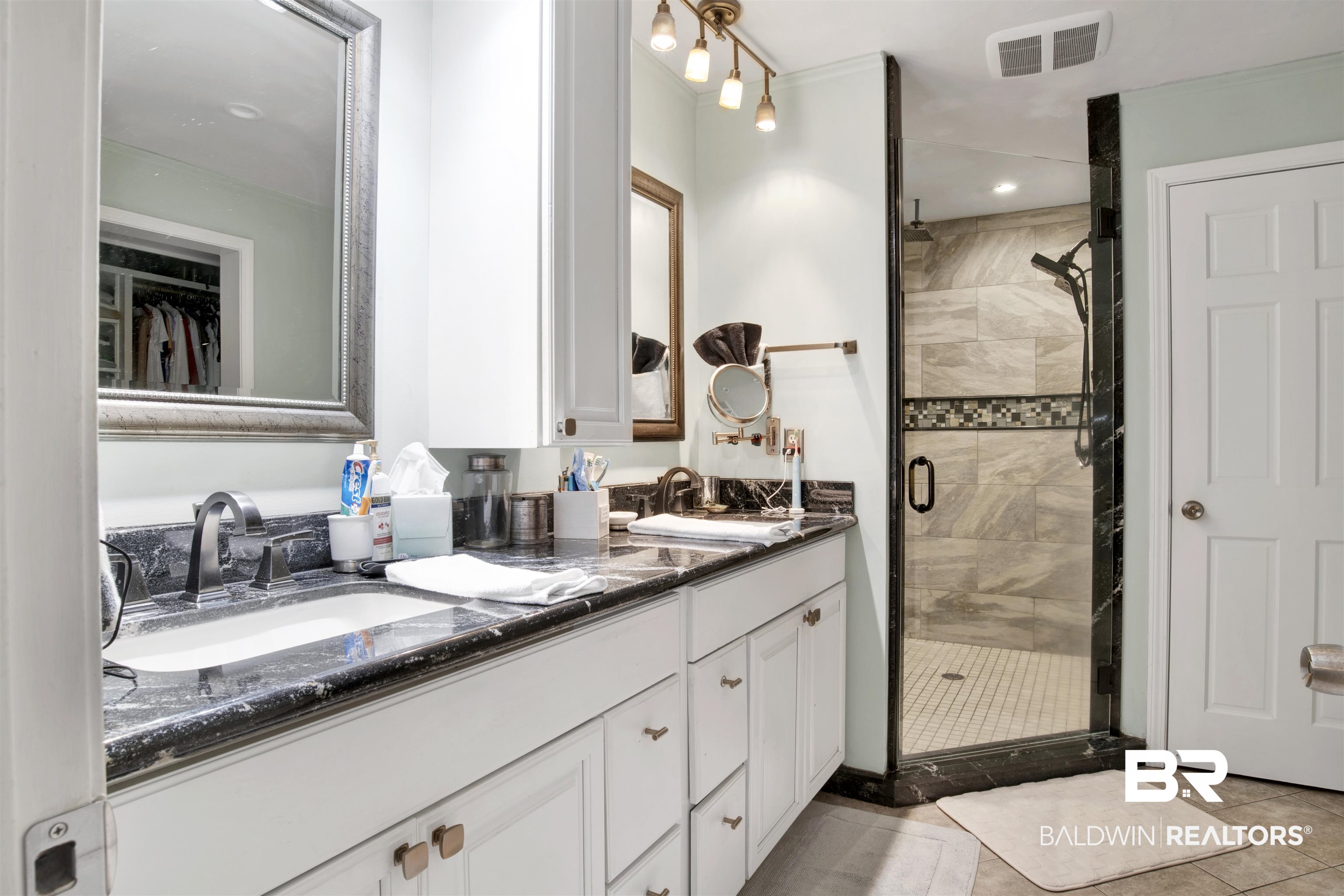 605 Van Avenue Daphne, AL 36526 - Photo 19 of 37 Bathroom with vanity, tile patterned flooring, and an enclosed shower