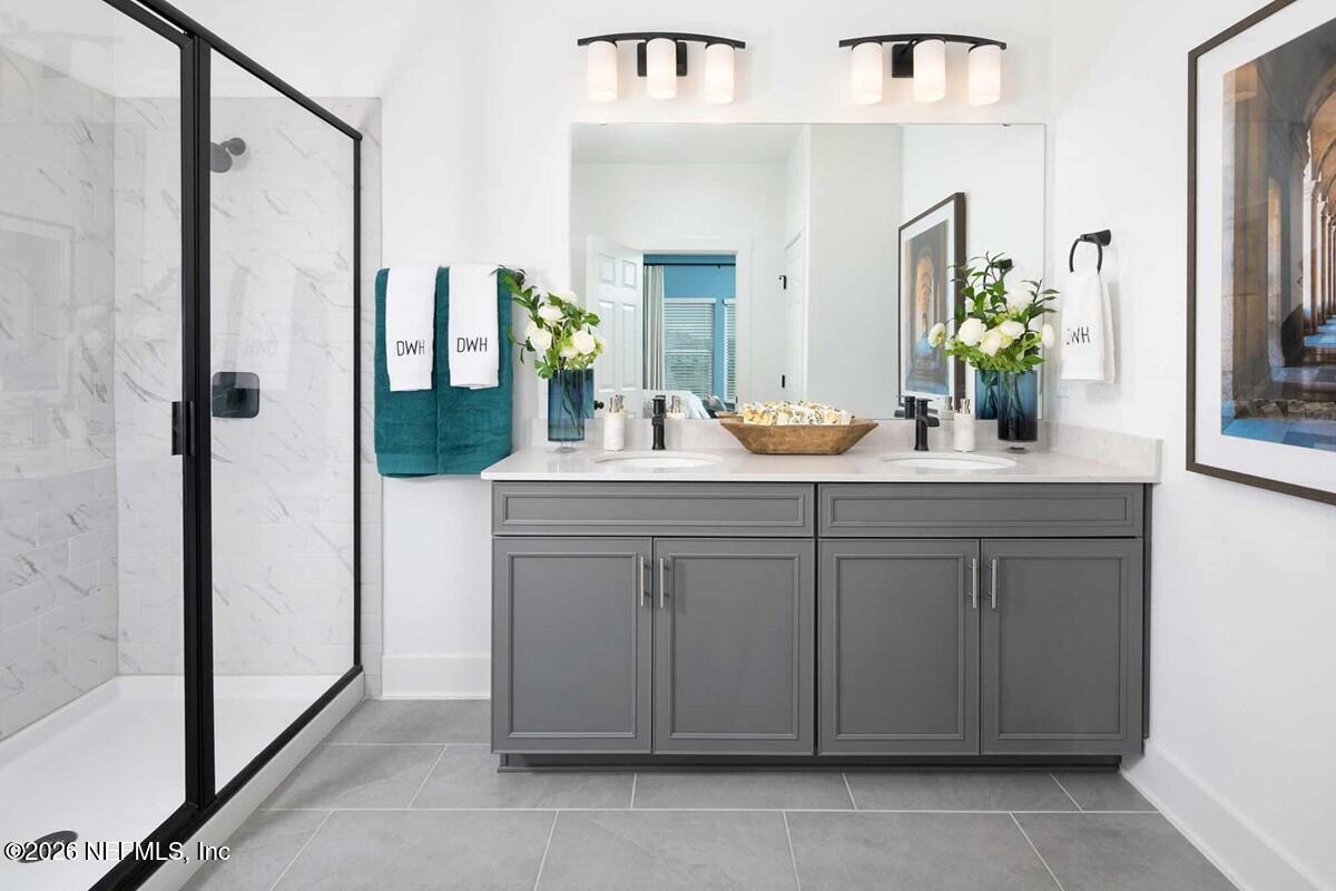 9925 Element Road Jacksonville, FL 32256 - Photo 6 of 7 a bathroom with a double vanity sink and mirror