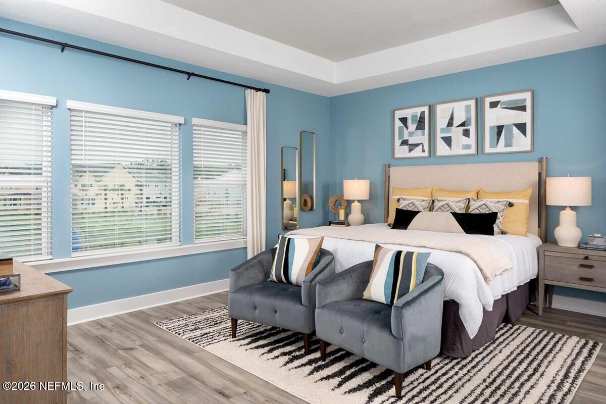 9925 Element Road Jacksonville, FL 32256 - Photo 7 of 7 a bedroom with a bed and wooden floor