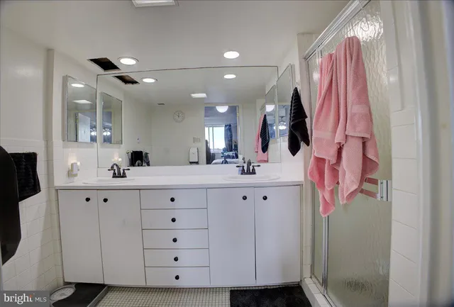 a bathroom with a sink vanity and mirror