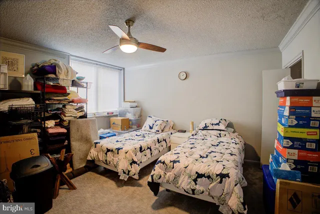 a bedroom with bed and a chandelier