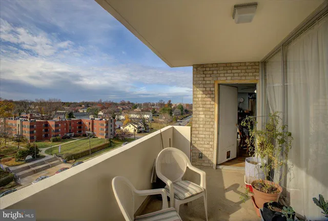 a view of a balcony with chair and potted plants