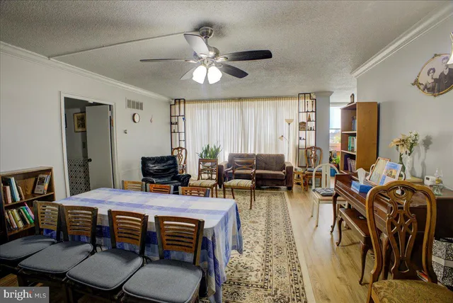 a view of a dining room with furniture and a chandelier