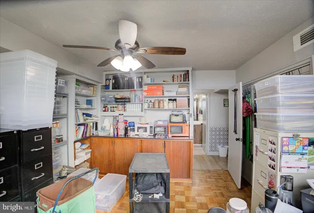 a living room with lots of furniture and clutter