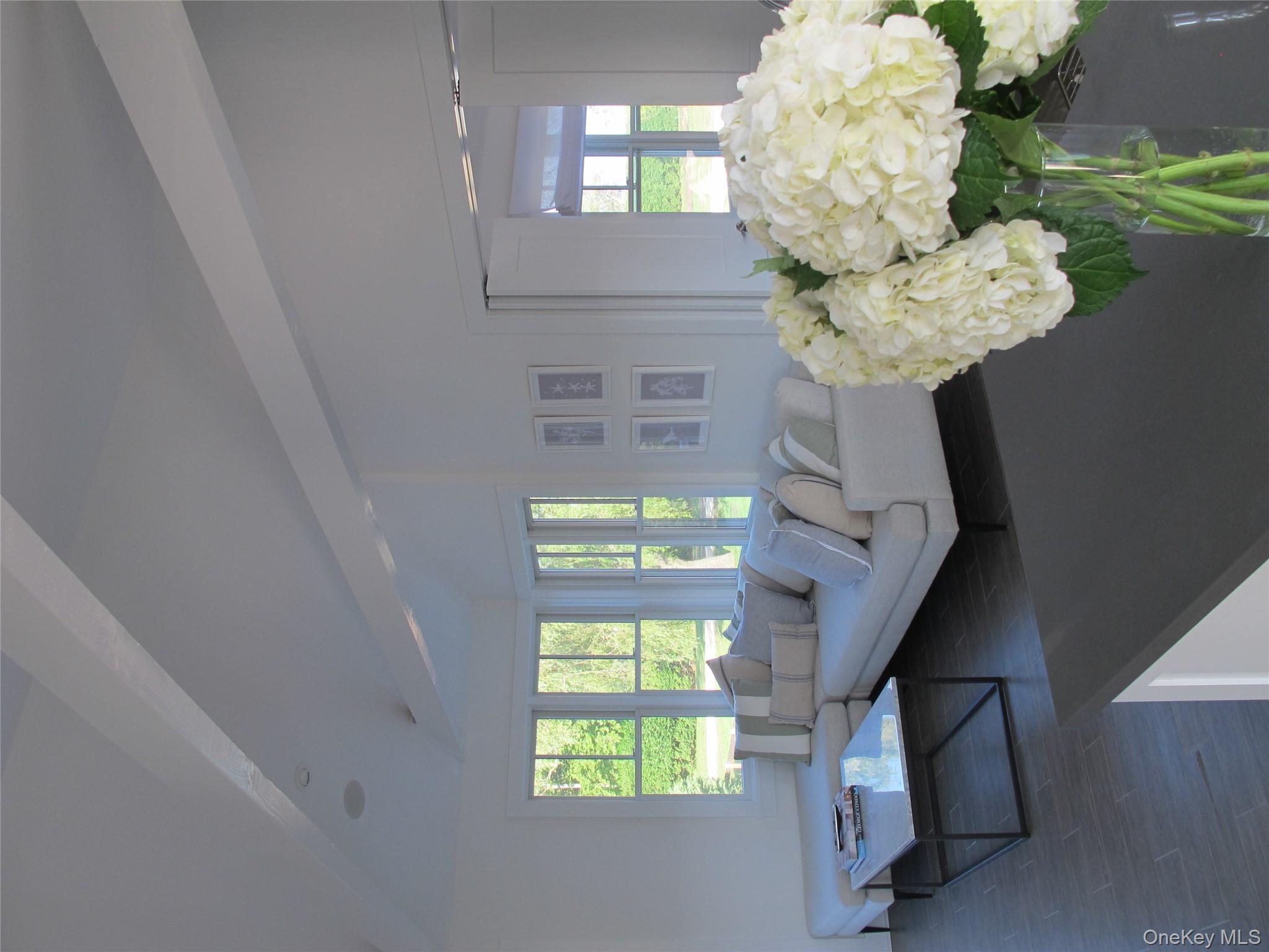 40 Tuthill Point Road East Moriches, NY 11940 - Photo 23 of 28 a living room with furniture and flowers