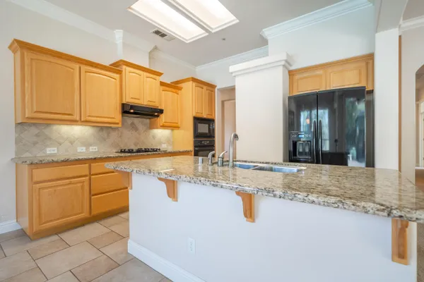 a kitchen with granite countertop a sink and cabinets
