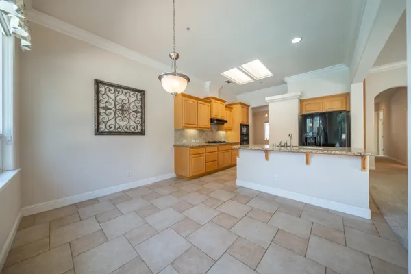 a kitchen with a sink window and cabinets