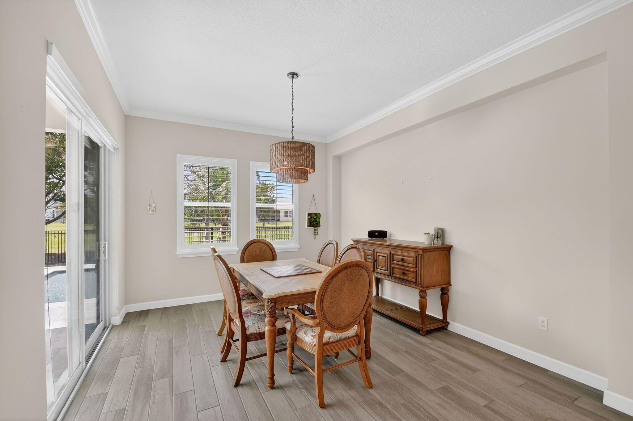 1055 Ember Ridge Run Loxahatchee, FL 33470 - Photo 24 of 103 a view of a dining room with furniture window and wooden floor