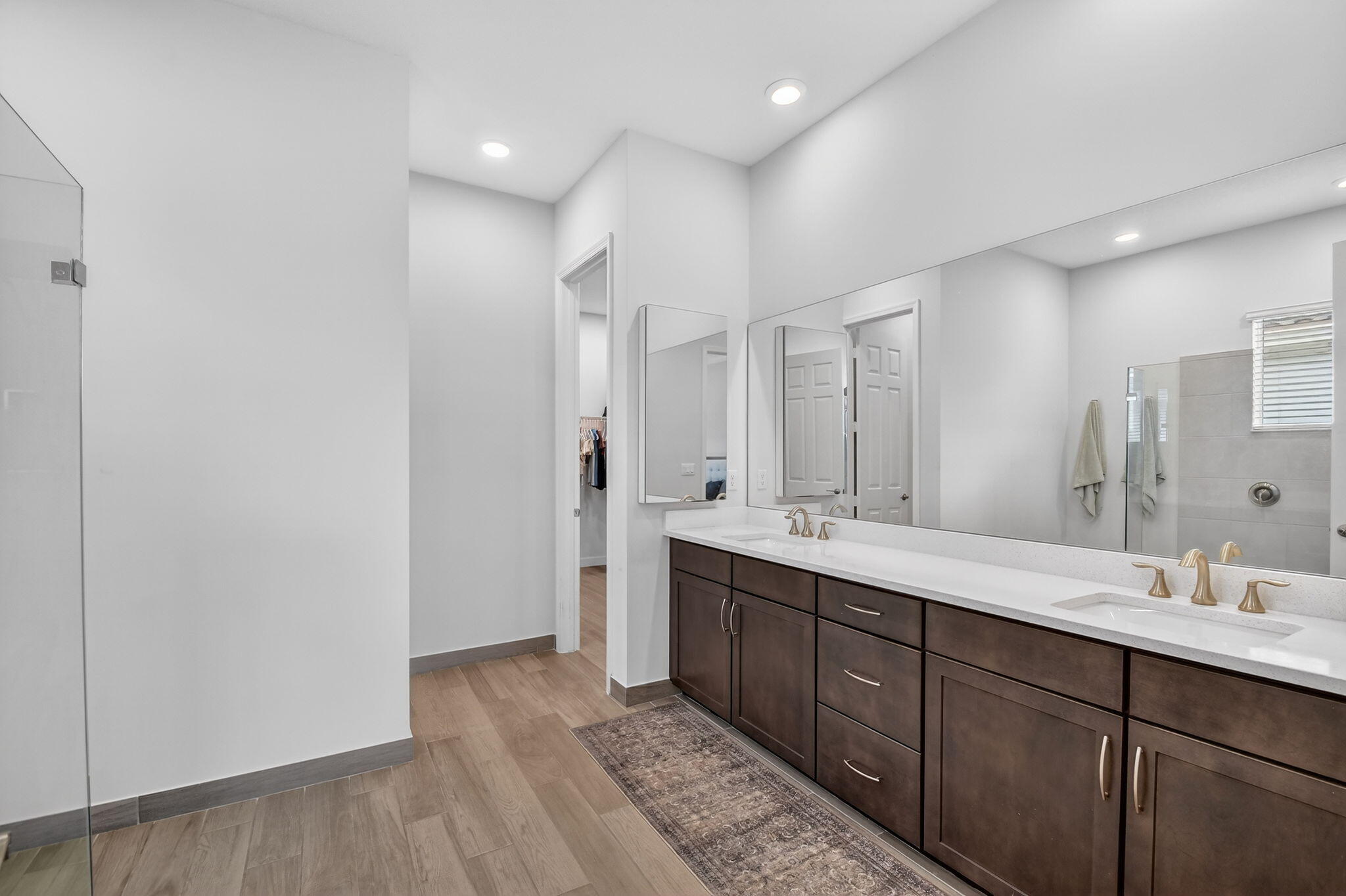 1055 Ember Ridge Run Loxahatchee, FL 33470 - Photo 30 of 103 a spacious bathroom with a double vanity sink and mirror