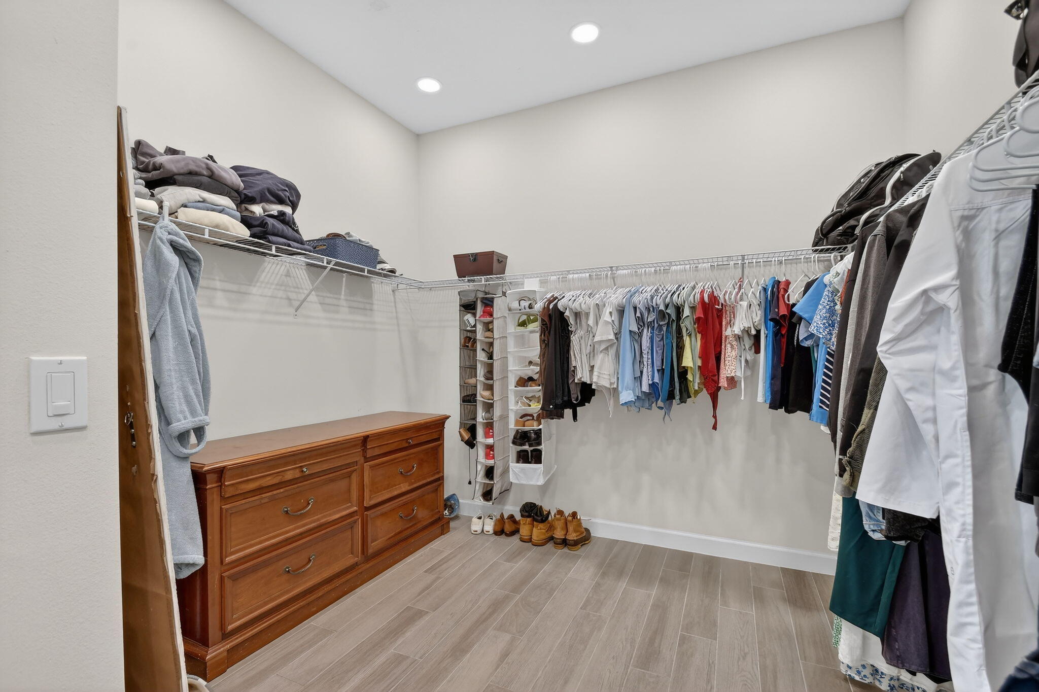 1055 Ember Ridge Run Loxahatchee, FL 33470 - Photo 33 of 103 a view of walk in closet with clothes and shoes