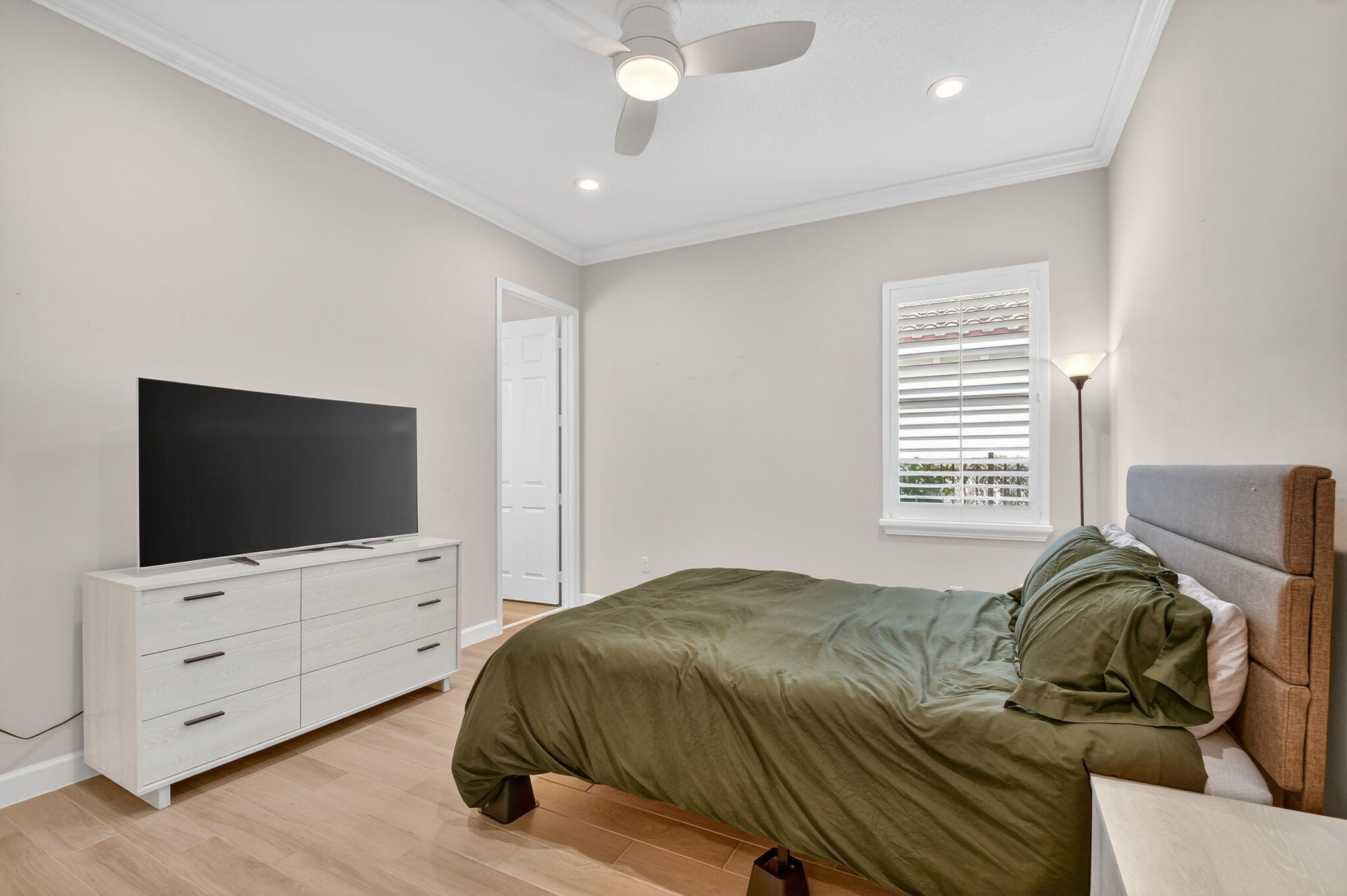 1055 Ember Ridge Run Loxahatchee, FL 33470 - Photo 34 of 103 a bedroom with a bed and a flat screen tv