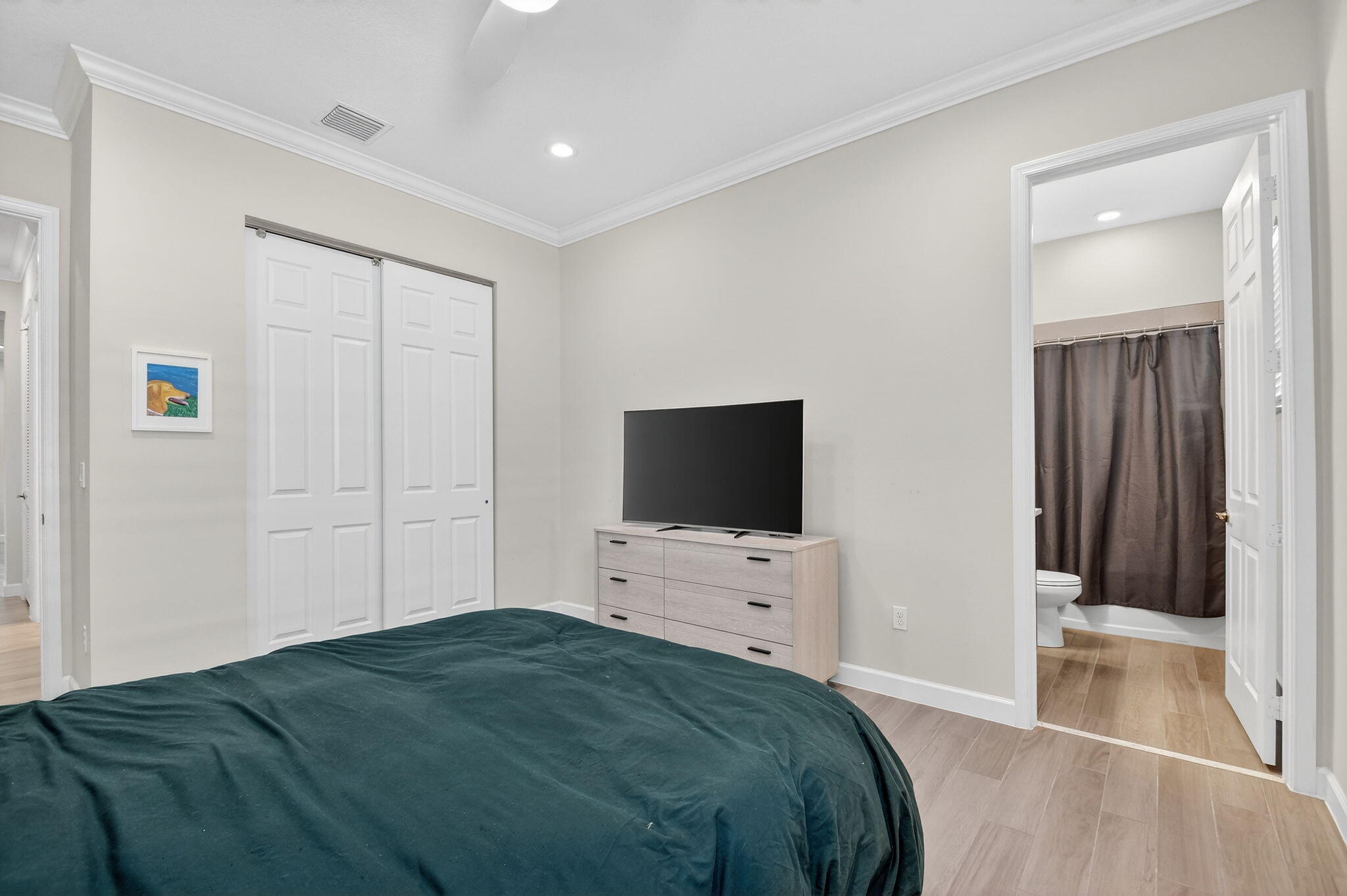 1055 Ember Ridge Run Loxahatchee, FL 33470 - Photo 36 of 103 a bedroom with a bed and a flat tv screen on wall