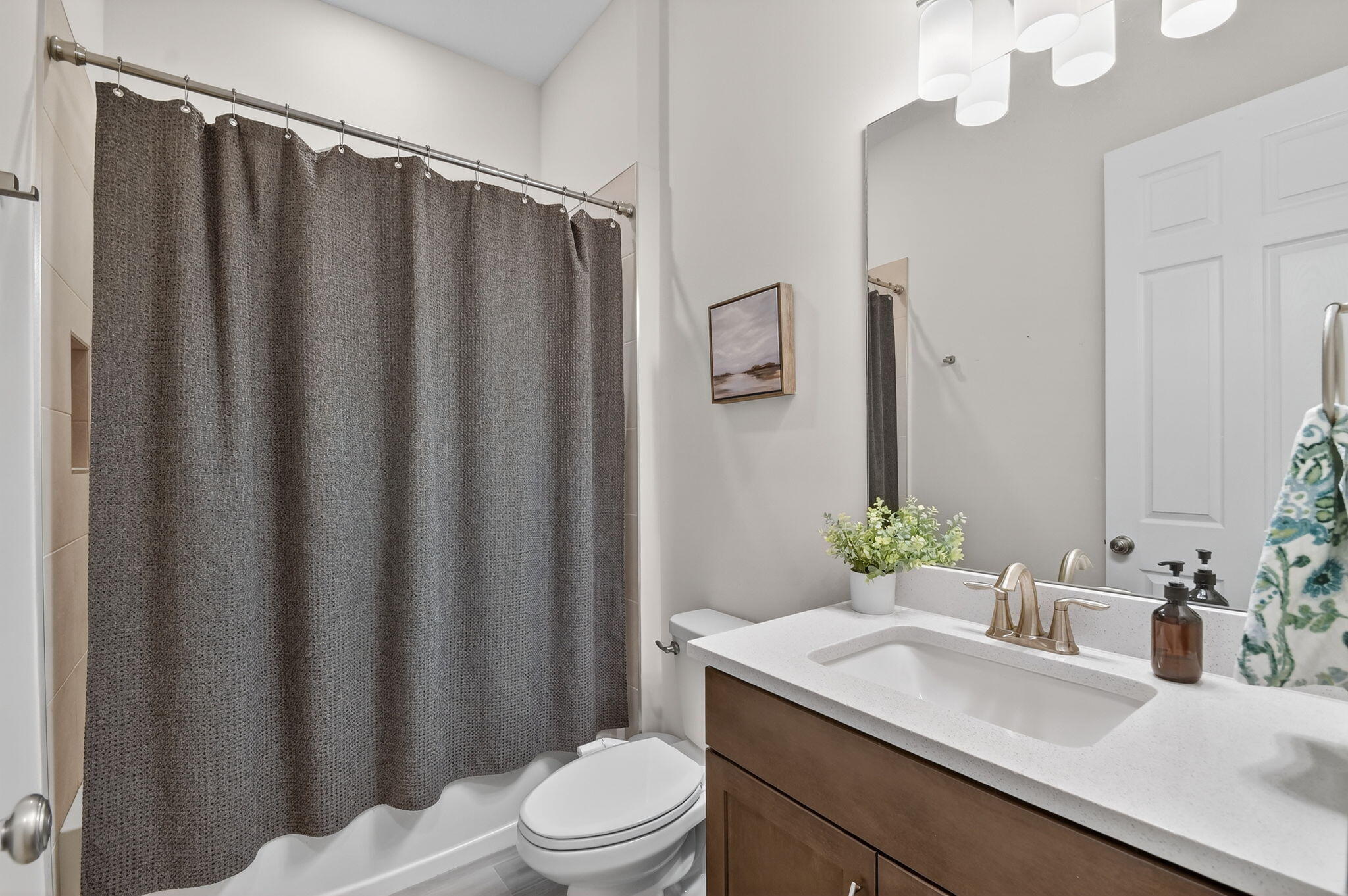 1055 Ember Ridge Run Loxahatchee, FL 33470 - Photo 41 of 103 a bathroom with a sink a toilet a mirror and shower curtain
