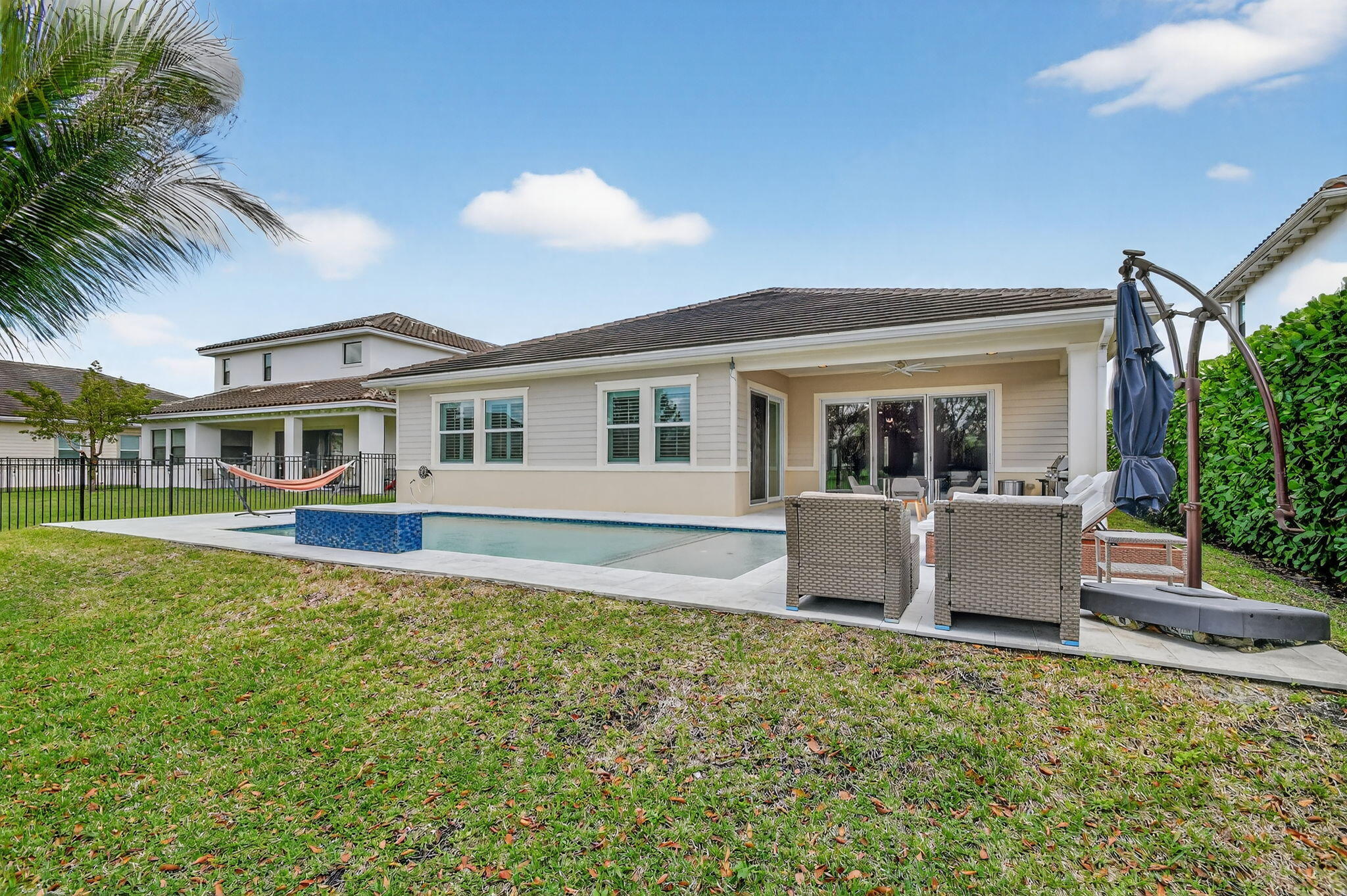 1055 Ember Ridge Run Loxahatchee, FL 33470 - Photo 57 of 103 front view of house with a yard and potted plants