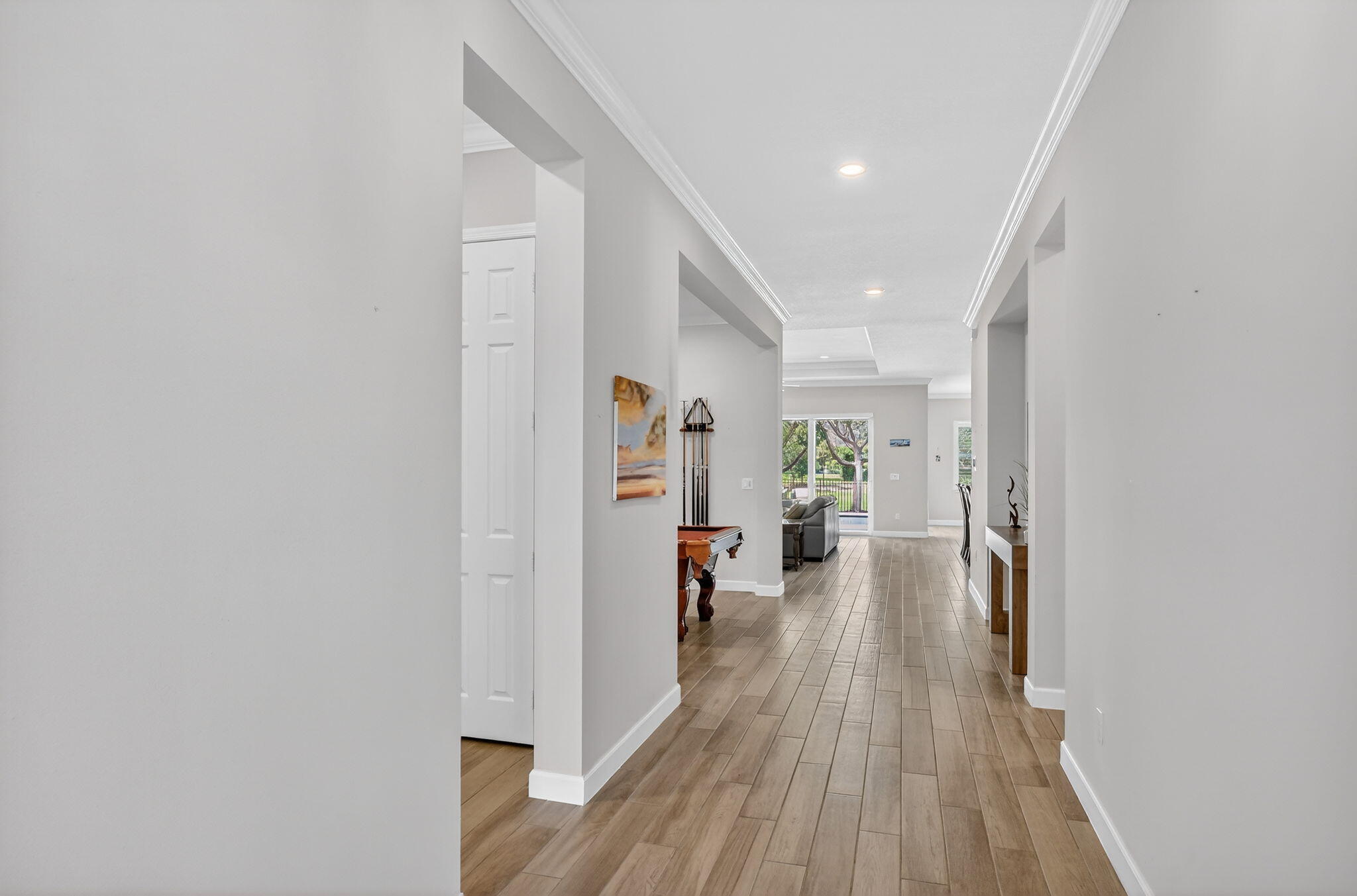 1055 Ember Ridge Run Loxahatchee, FL 33470 - Photo 8 of 103 a view of a hallway view with wooden floor and furniture