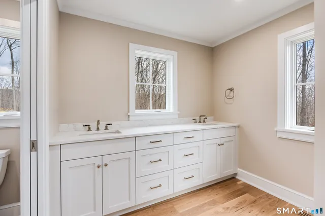 a front view of a house with a garden and yard