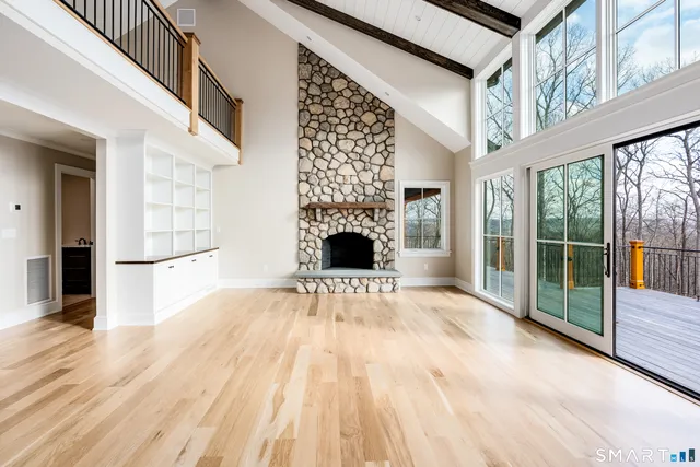 a large kitchen with stainless steel appliances granite countertop a stove a sink dishwasher a microwave oven with cabinets and wooden floor