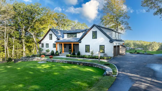 a front view of a house with a yard table and chairs