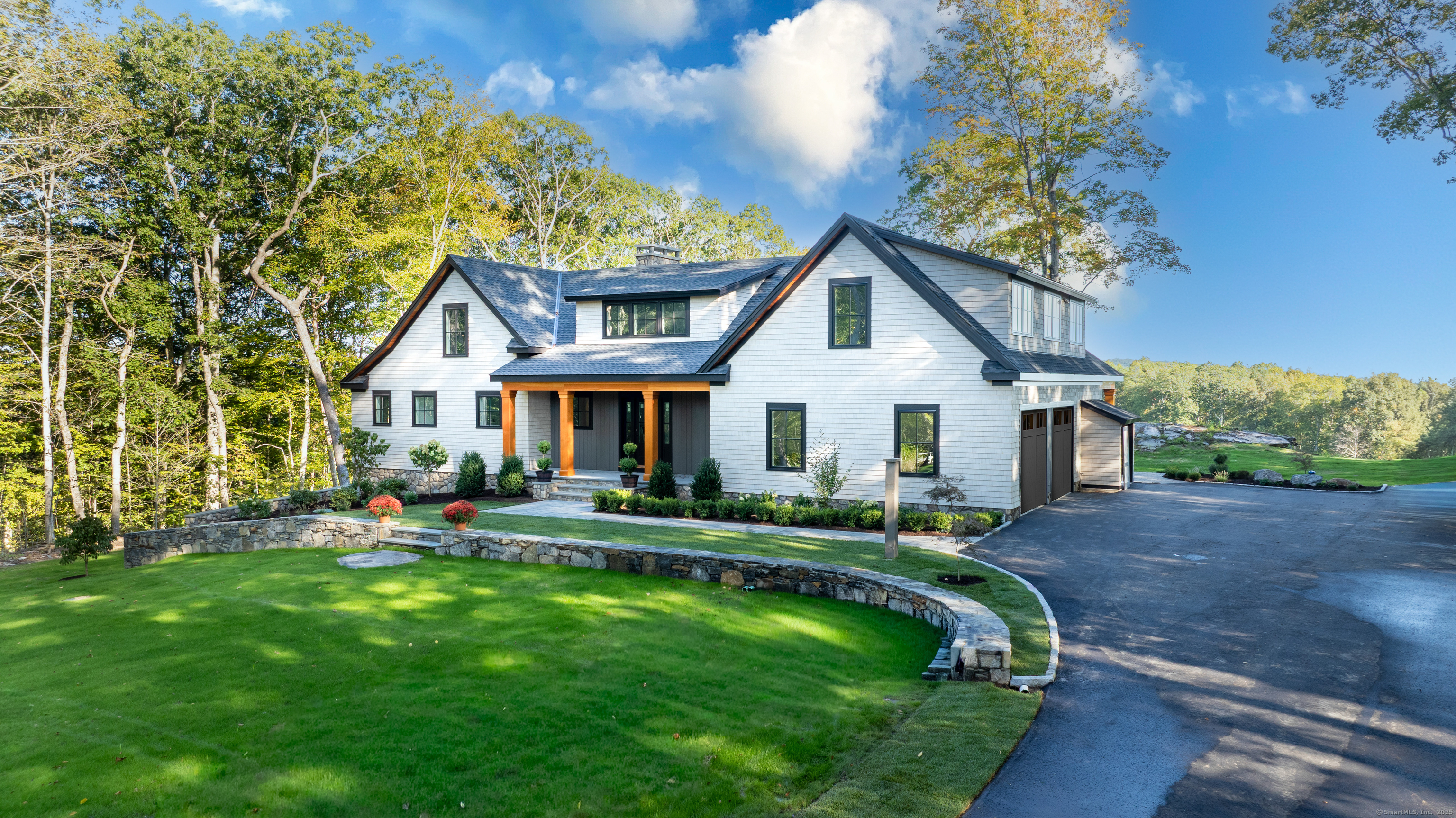 703 Fox Hopyard Road East Haddam, CT 06423 - Photo 4 of 38 a front view of a house with a yard table and chairs