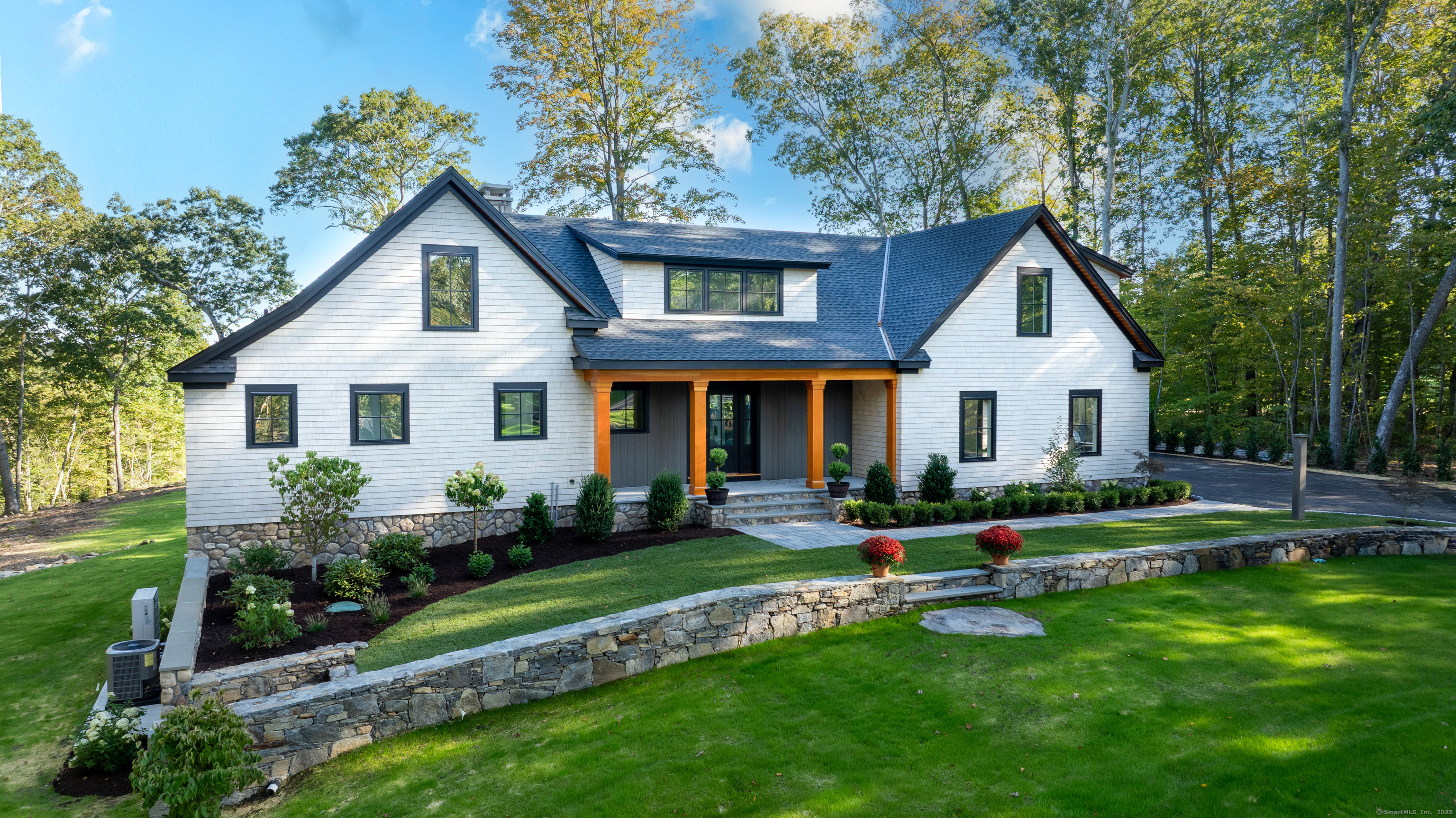 703 Fox Hopyard Road East Haddam, CT 06423 - Photo 5 of 38 a front view of a house with a yard and garage