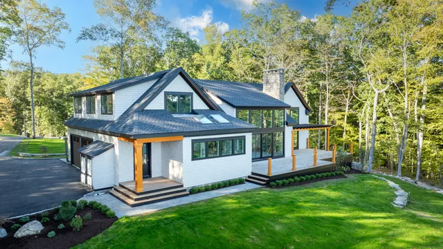 a front view of a house with a garden
