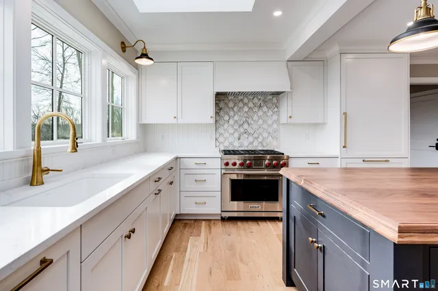 a bathroom with a sink a toilet and a window