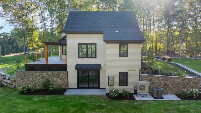 a front view of a house with a garden and yard