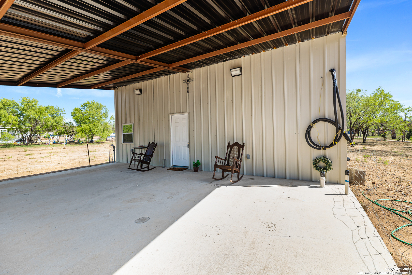128 County Road 2672 Devine, TX 78016 - Photo 11 of 44 a backyard of a house with table and chairs