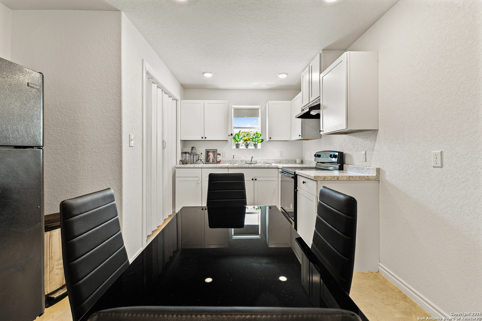128 County Road 2672 Devine, TX 78016 - Photo 15 of 44 a kitchen with a sink stainless steel appliances and white cabinets