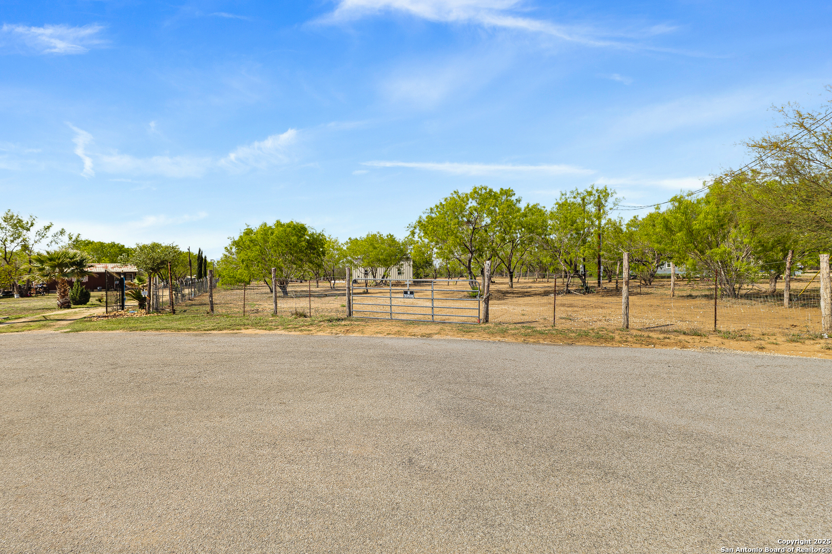 128 County Road 2672 Devine, TX 78016 - Photo 2 of 44 a view of a tennis court