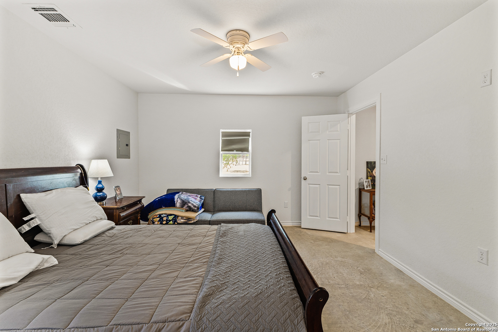 128 County Road 2672 Devine, TX 78016 - Photo 23 of 44 a bedroom with a bed and a ceiling fan