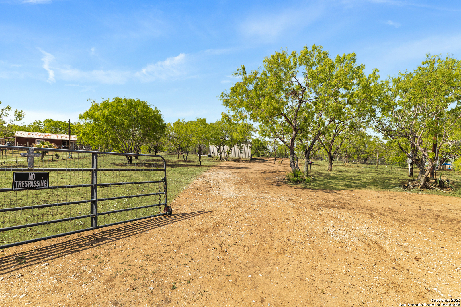 128 County Road 2672 Devine, TX 78016 - Photo 3 of 44 a view of a yard with wooden fence