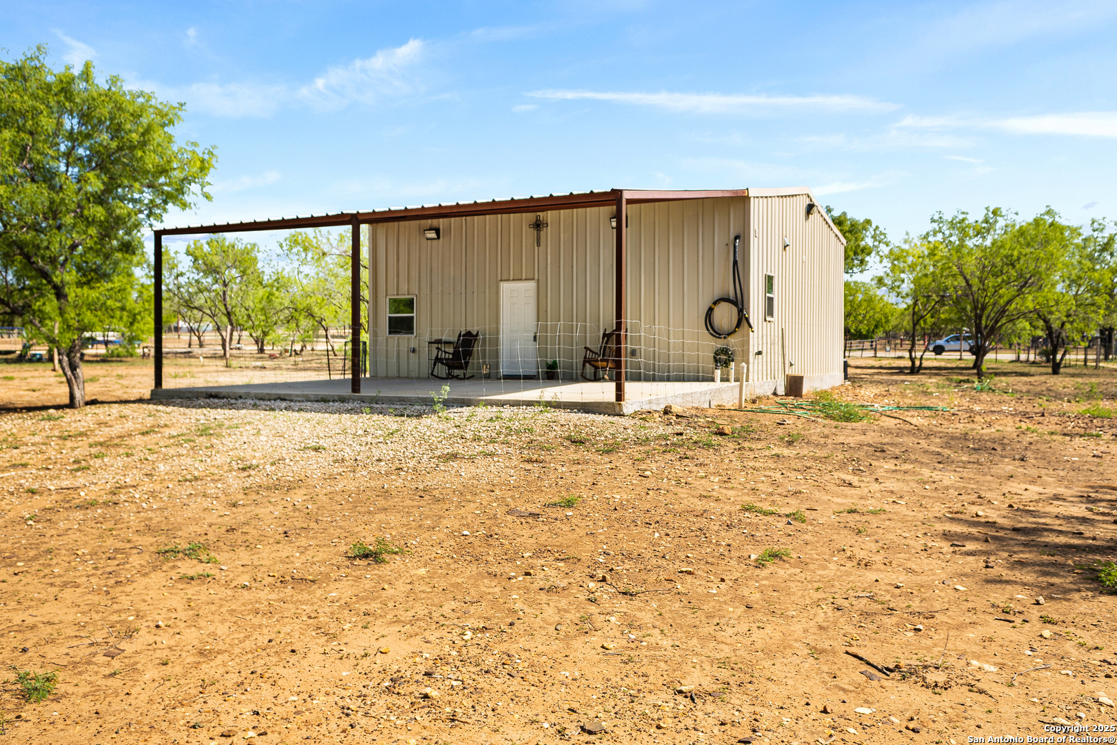 128 County Road 2672 Devine, TX 78016 - Photo 6 of 44 a swimming pool with outdoor seating and yard