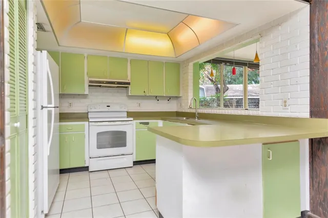 a kitchen with a sink cabinets and a stove top oven