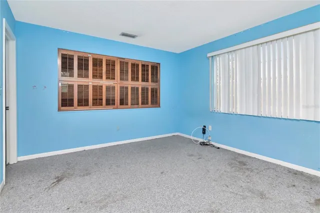 a bathroom with a granite countertop toilet a sink and a bathtub
