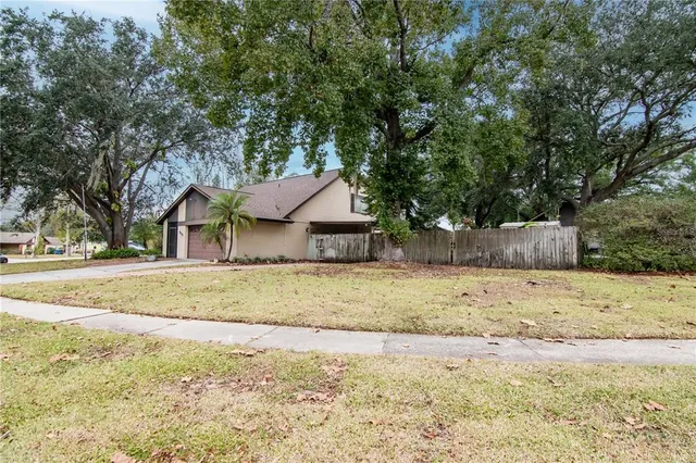 a view of a house with a yard covered in snow
