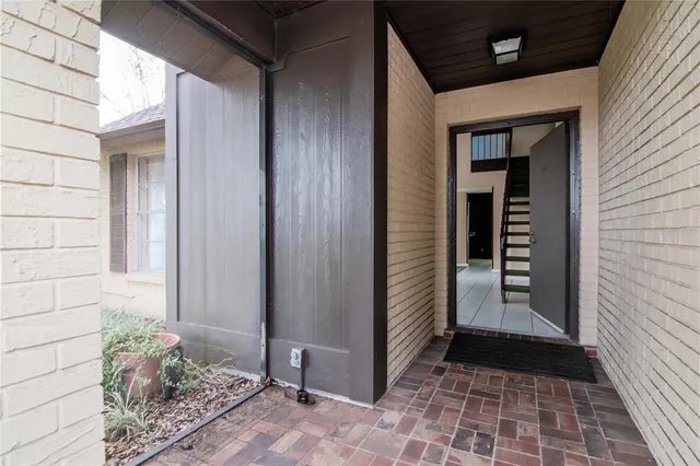 a view of a house with a yard and large tree