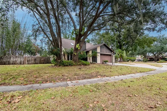 a view of a yard with a house in the background