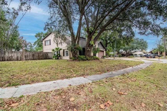 a view of empty room with fireplace and windows