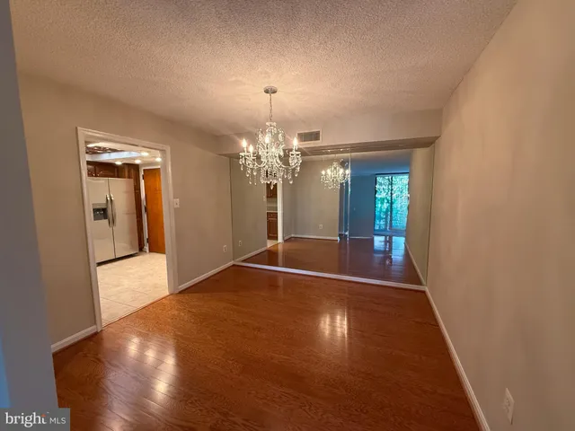 a kitchen with stainless steel appliances granite countertop a refrigerator a sink a stove top oven and cabinets