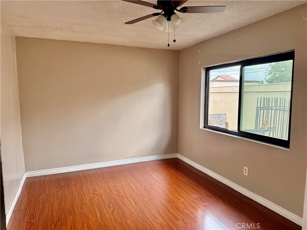 264 West Jackson Street Rialto, CA 92376 - Photo 11 of 32 wooden floor in an empty room with a window