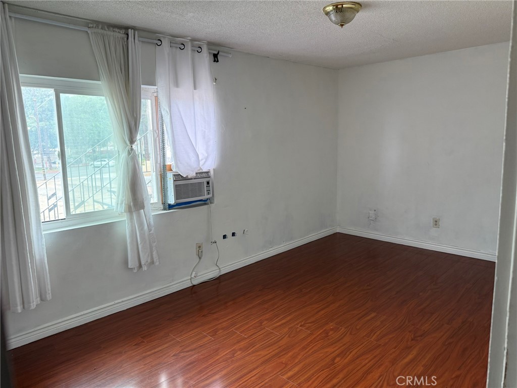 264 West Jackson Street Rialto, CA 92376 - Photo 14 of 32 an empty room with wooden floor and windows