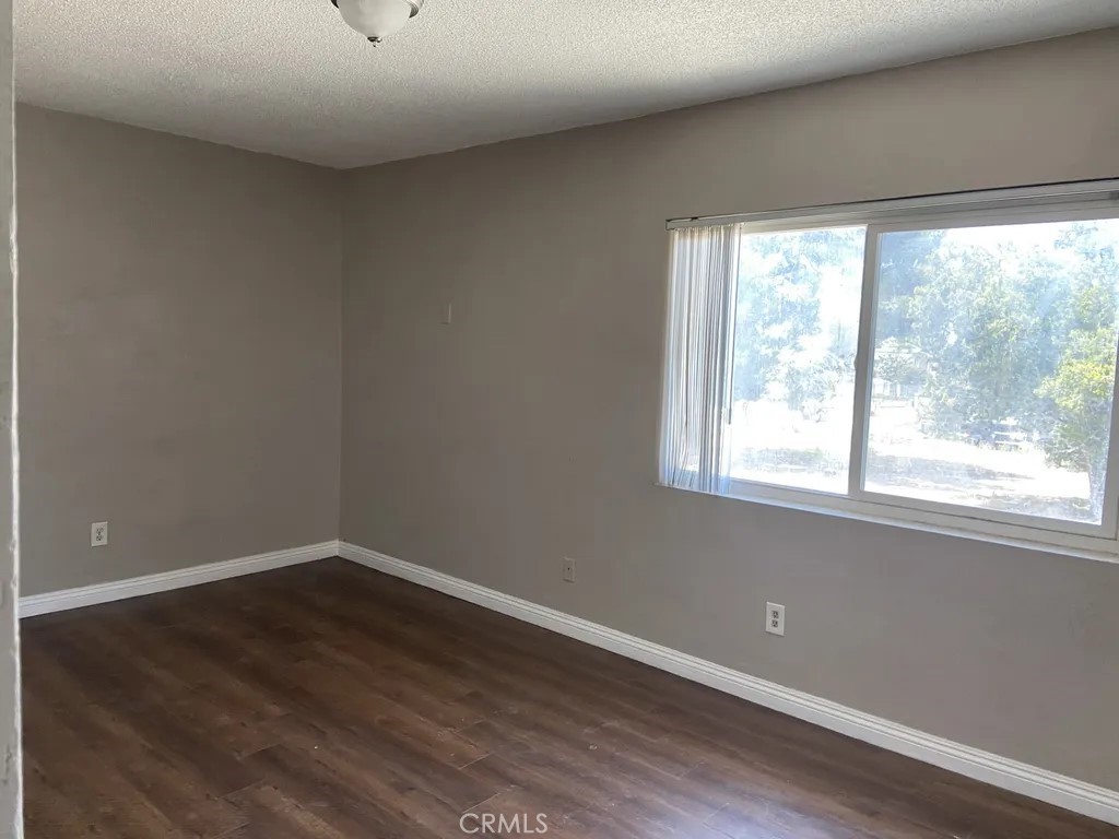 264 West Jackson Street Rialto, CA 92376 - Photo 5 of 32 wooden floor in an empty room with a window