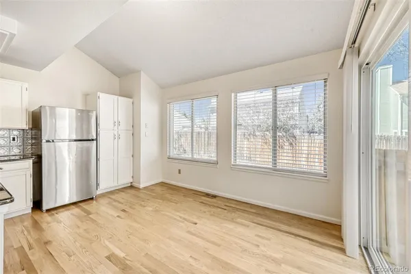a view of a kitchen with a refrigerator cabinet and a window
