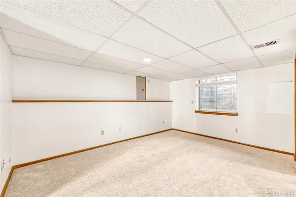 an empty room with windows and closet