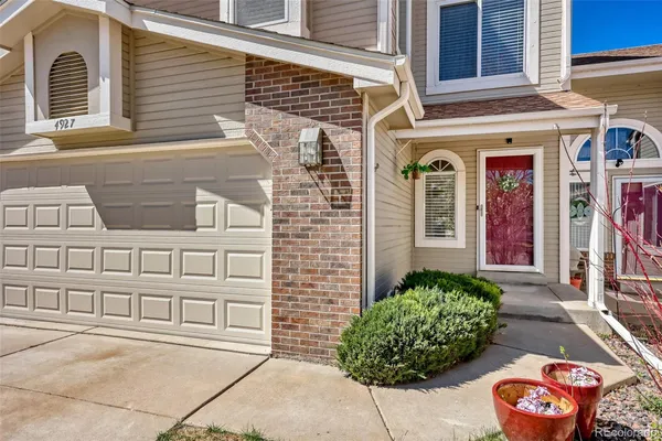 a view of a brick house with potted plants