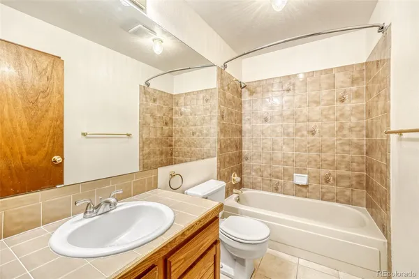 a bathroom with a granite countertop sink mirror and