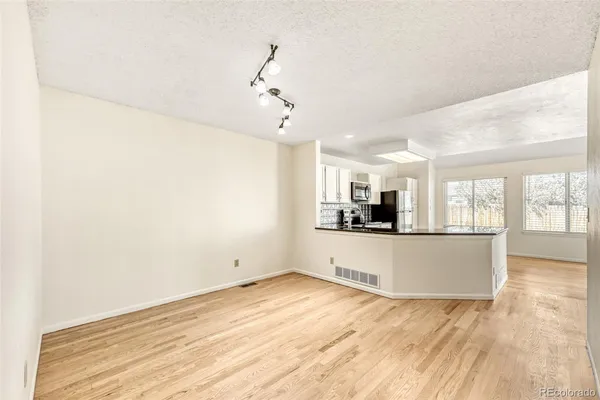 a view of a kitchen with a sink and wooden floor
