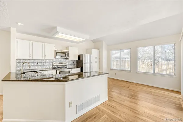 a kitchen with stainless steel appliances granite countertop a sink and cabinets