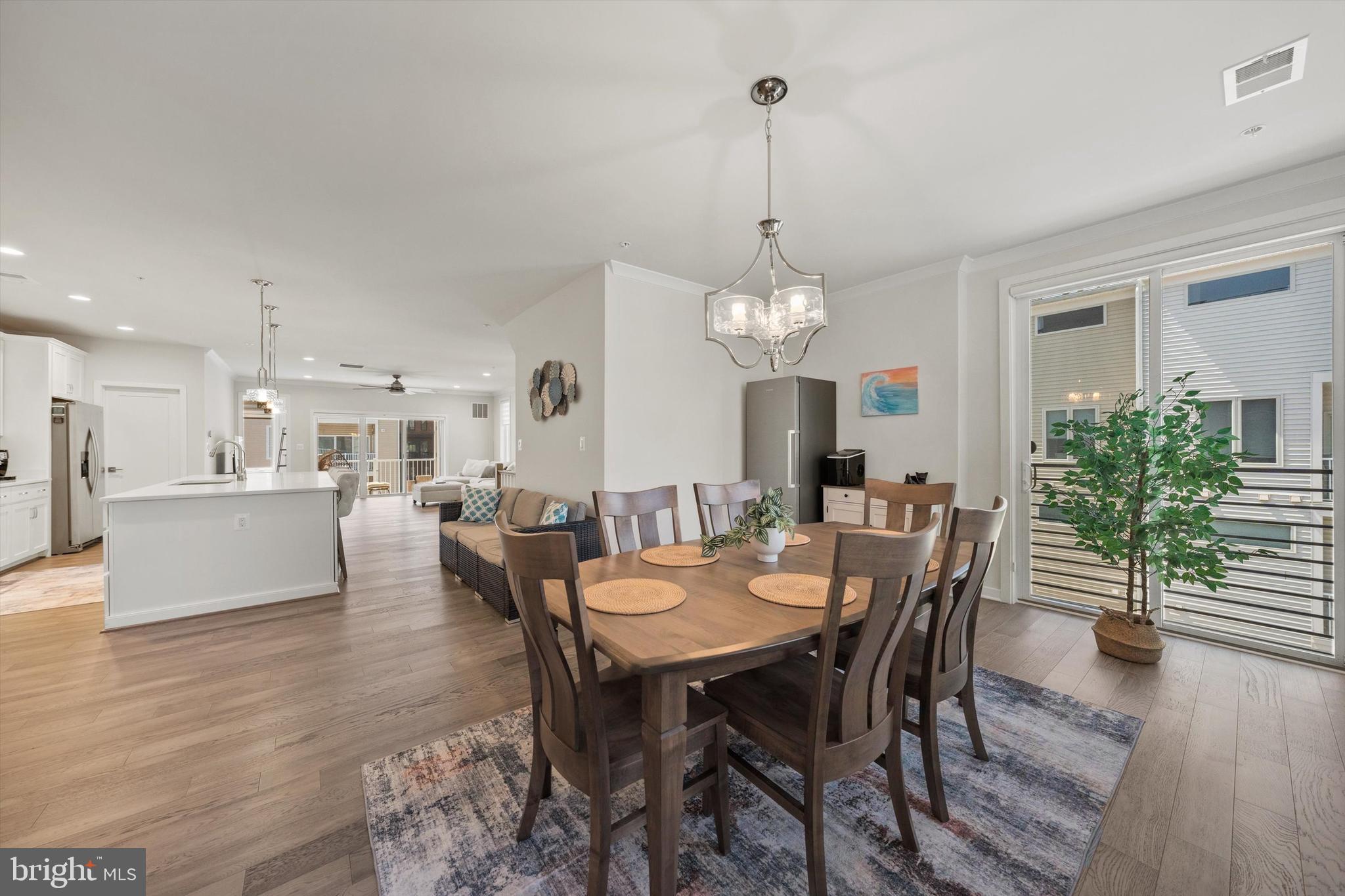 43179 Mongold Square Ashburn, VA 20148 - Photo 14 of 46 a view of a dining room and livingroom with furniture wooden floor a chandelier